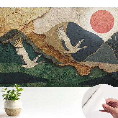 Tapeta s motivem jeřábů a malebné krajiny při rudém západu slunce