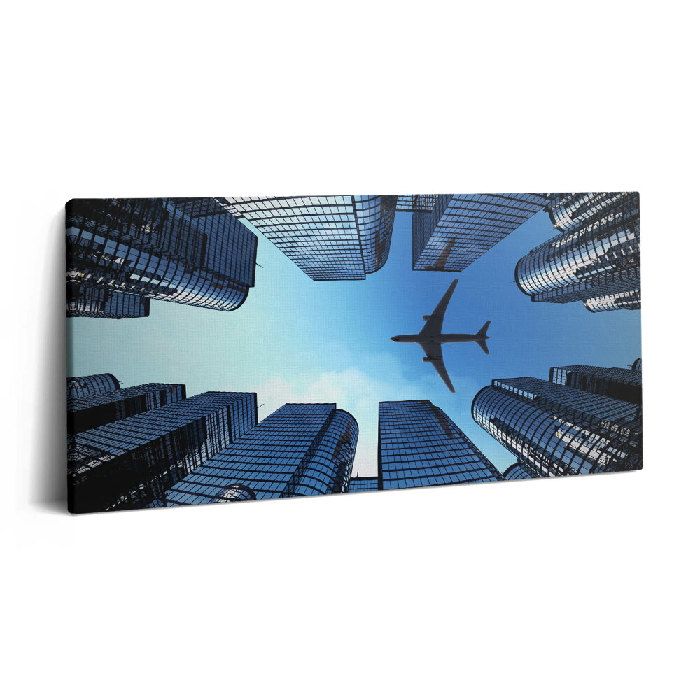 Obraz na plátně 120x60 cm Letadlo nad budovami