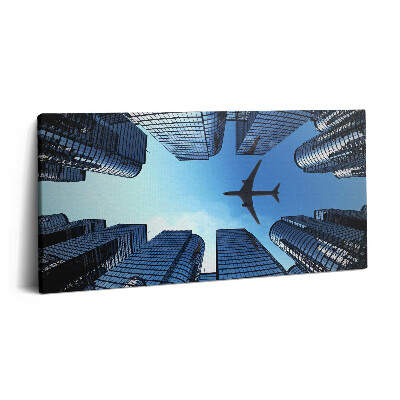 Obraz na plátně 120x60 cm Letadlo nad budovami