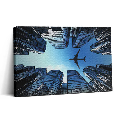 Obraz na plátně 30x20 Letadlo nad budovami