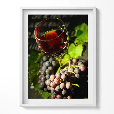 Obraz v rámu Sklenka červeného vína a hroznů