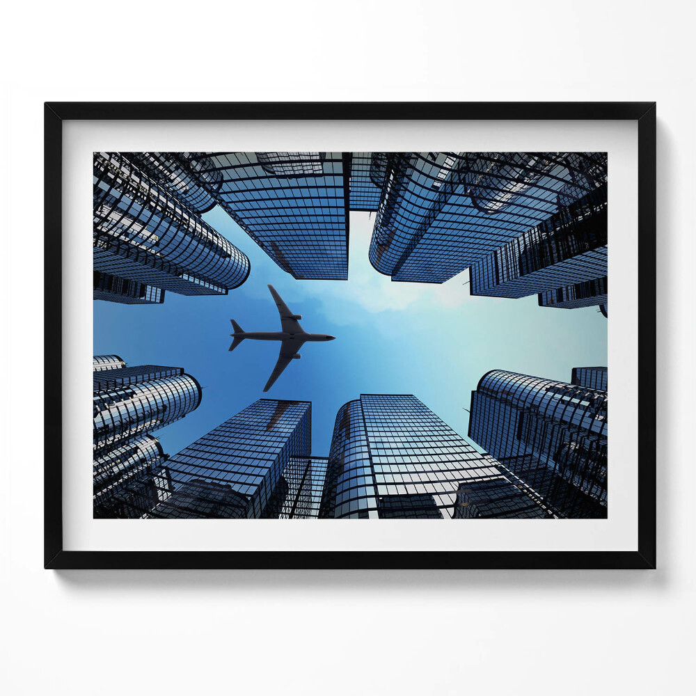 Obraz s rámem Letadlo nad budovami
